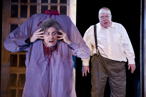 Jesse Merlin loses his head as Dr. Hill and George Wendt is Dean Halsey in _Re-Animator The Musical_ Photo by Thomas Hargis