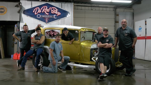 Billy Derian Sr., Billy Derian Jr., Jeff Thisted, Art Gil, Mike Dade, Shane Thisted and Steve Reck gather around the Model A for a candid group photo inside Da Rod Shop — Photo courtesy of Discovery Channel