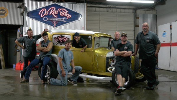 Billy Derian Sr., Billy Derian Jr., Jeff Thisted, Art Gil, Mike Dade, Shane Thisted and Steve Reck gather around the Model A for a candid group photo inside Da Rod Shop — Photo courtesy of Discovery Channel