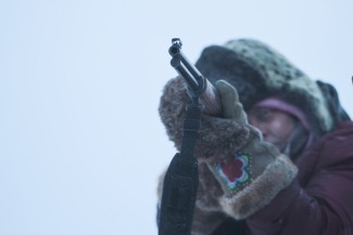 Sue Aikens, star of 'Life Below Zero,' takes aim with her rifle in Kavik, Alaska — Photo courtesy of © 2012 BBC Worldwide Ltd. "All Rights Reserved" 