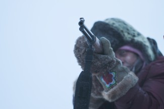 Sue Aikens, star of 'Life Below Zero,' takes aim with her rifle in Kavik, Alaska — Photo courtesy of © 2012 BBC Worldwide Ltd. "All Rights Reserved"