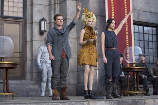 From left to right: Josh Hutcherson ("Peeta Mellark," left), Elizabeth Banks ("Effie Trinket," center) and Jennifer Lawrence ("Katniss Everdeen," right) star in Lionsgate Home Entertainment's 'The Hunger Games: Catching Fire'. Photo Courtesy of Murray Close