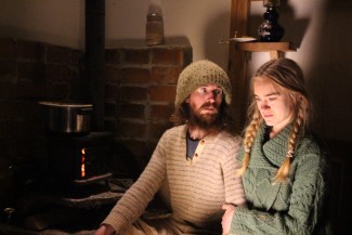 Mars Hill, NC, USA: Tony looks at Amelia as they sit by the fire at night. Photo Credit: National Geographic Television/Lindsay Cooper