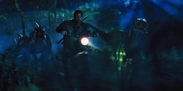 Owen (Chris Pratt) leads the raptors on a mission in Jurassic World. Photo courtesy of Universal Pictures and Amblin Entertainment
