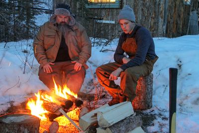Todd and Hunter Hoffman sit around a campfire on Gold Rush. Photo courtesy of Discovery Channel / Edward Gorsuch.