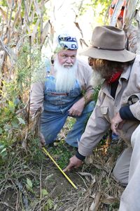 From left, Jeff and Trapper take a look at measurements on Mountain Monsters. Photo courtesy of Destination America / Jeremy Brigden.