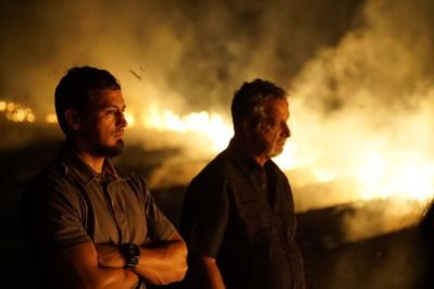 From left, Detective Aubrey St. Angelo and Retired Detective Rhodes Sanchez watch a sugar cane field burn on Killing Fields. Photo courtesy of Discovery Channel.