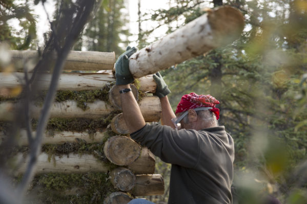 Heimo Korth works on his wood log cabin. Photo courtesy of Discovery Channel.