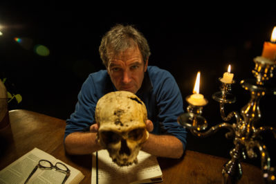 Dr. Mark Evans holds a skull on the TV special Yeti or Not. Photo courtesy of Animal Planet.