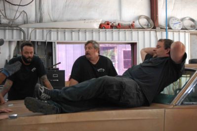 Jordan Butler takes a break as Kevin Clark and Tom Smith discuss the Plymouth build. Photo courtesy of Discovery Channel.
