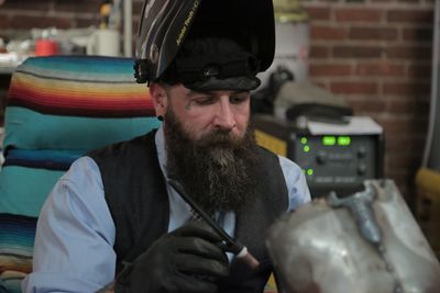 Jason Wilson works on a bike and trike on Sacred Steel Bikes, a new reality series. Photo courtesy of Discovery Channel.
